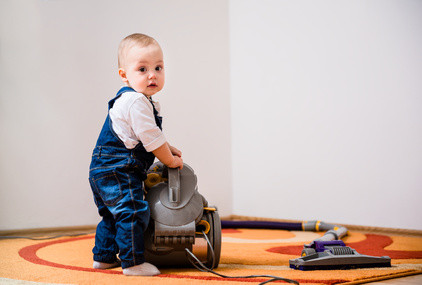 Cleaning home - baby with vacuum cleaner